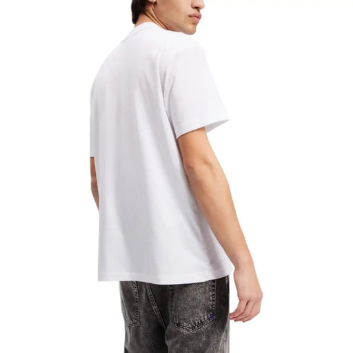 White short-sleeved T shirt featuring a black logo patch for casual style