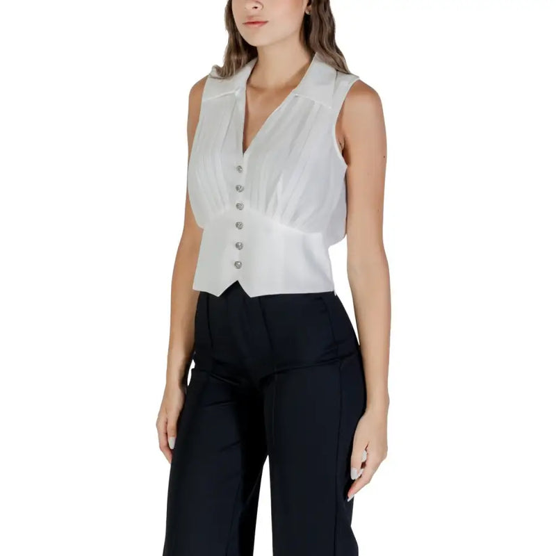 White sleeveless collared blouse with button-up front and gathered waist for Fall Winter fashion