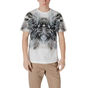 Man wearing a white T-shirt with black and gray palm leaf pattern and khaki pants
