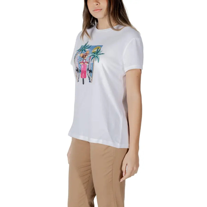 White cotton t-shirt featuring a colorful embroidered graphic of a woman in a pink dress with palm trees