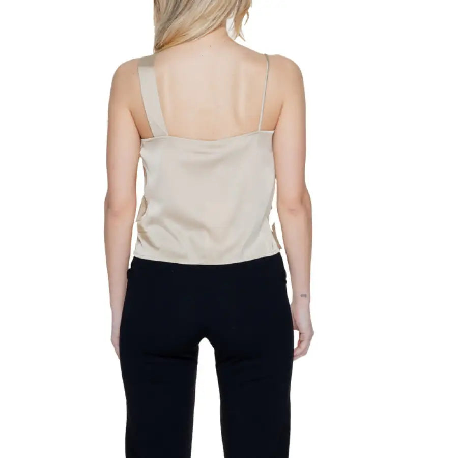 
                      
                        Woman in beige top and black pants showcasing urban city style clothing
                      
                    