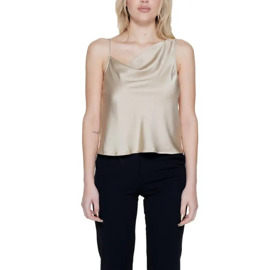 Woman in beige cow neck top - urban city style clothing
