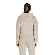Woman wearing Guess Women Beige Rhinestone Hooded Sweatshirt with matching sweatpants