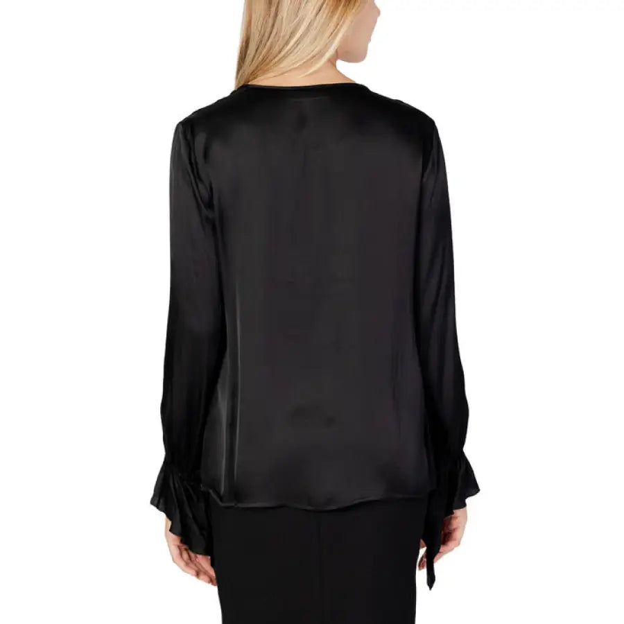 Woman in Sandro Ferrone knitwear, wearing black blouse and pants
