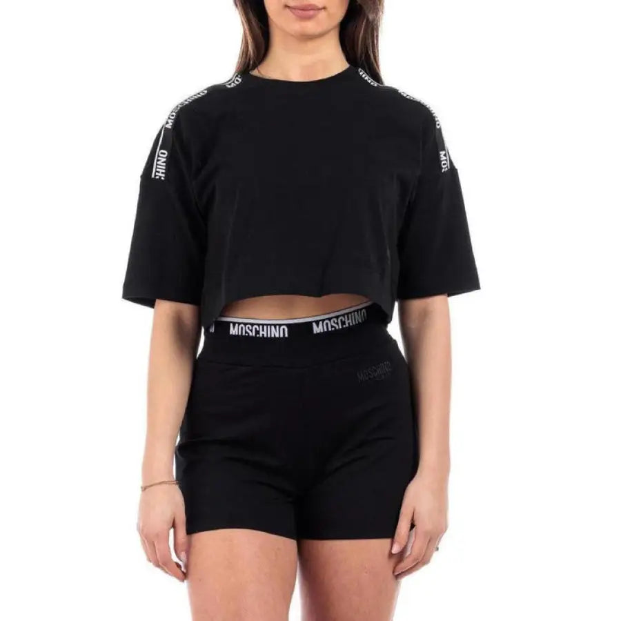 Woman in Moschino Underwear black crop top, showcasing urban style clothing