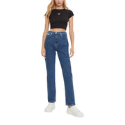 Woman wearing a black crop top and blue denim jeans for Women’s Black Crop Top and Blue Denim Jeans