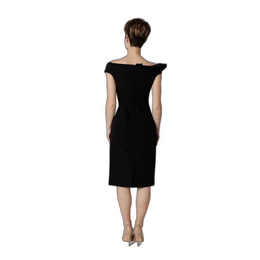 Woman in black Sandro Ferrone dress walking - Urban elegance