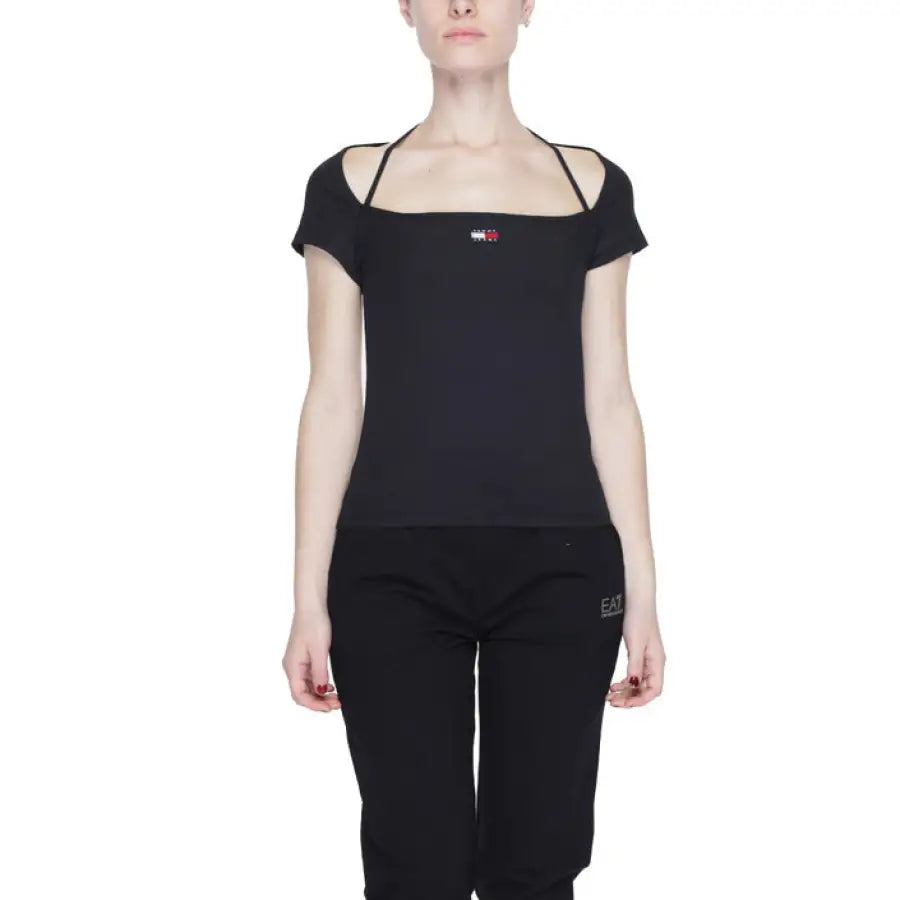 
                      
                        Tommy Hilfiger Jeans woman in black top with red heart
                      
                    