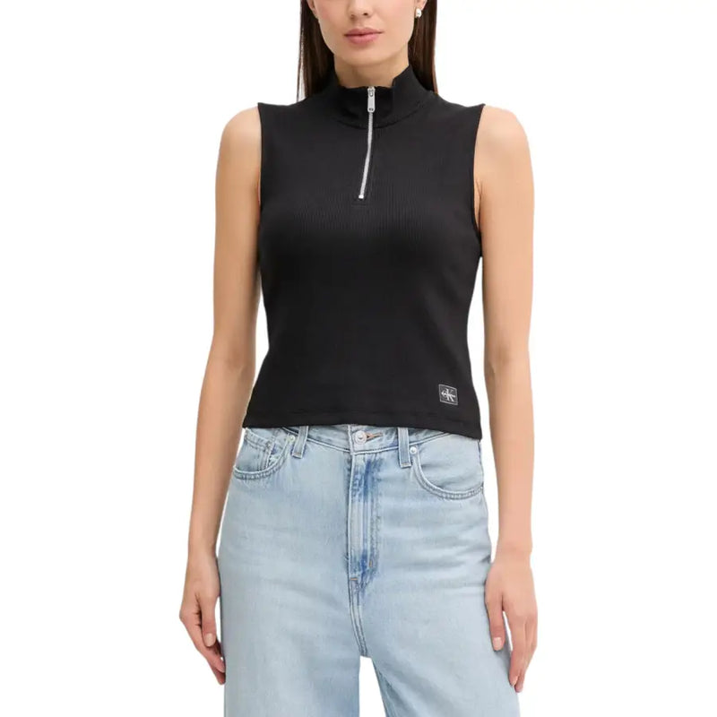 Woman wearing Calvin Klein Jeans white sleeveless zip turtleneck top and light wash denim