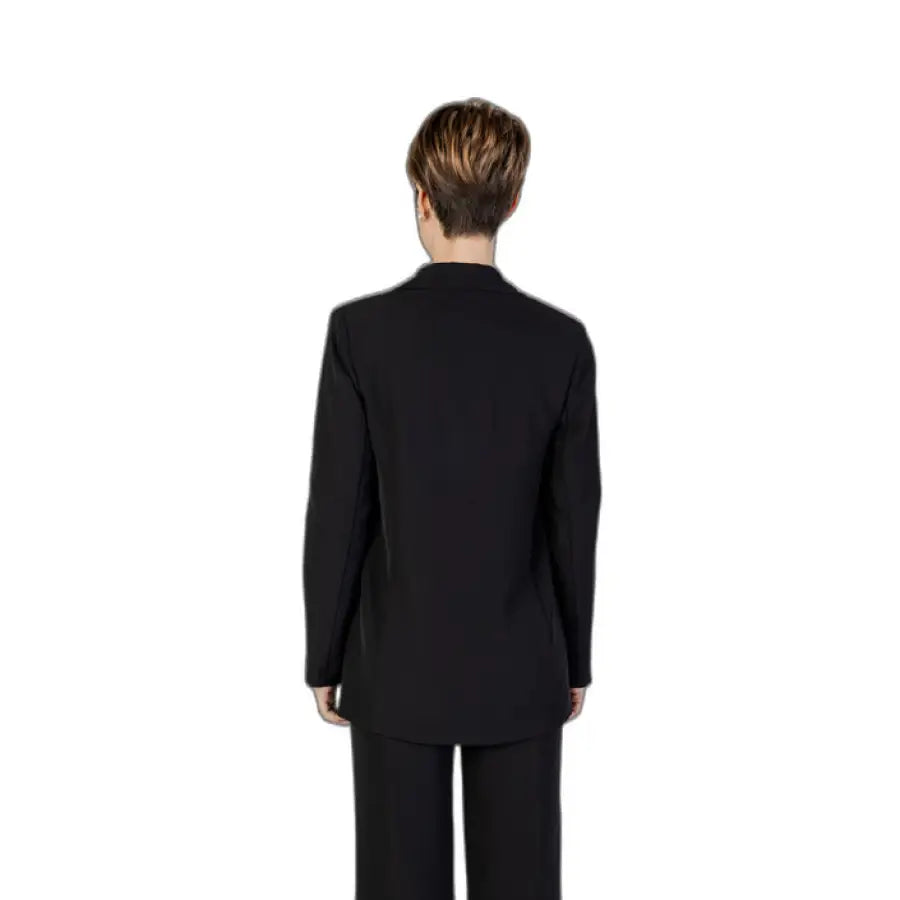 Woman in Sandro Ferrone black blazer suit