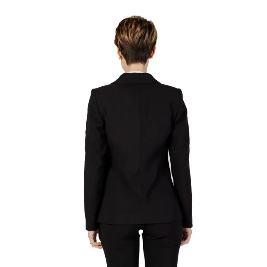 Woman modeling Sandro Ferrone women blazer in black suit and white shirt