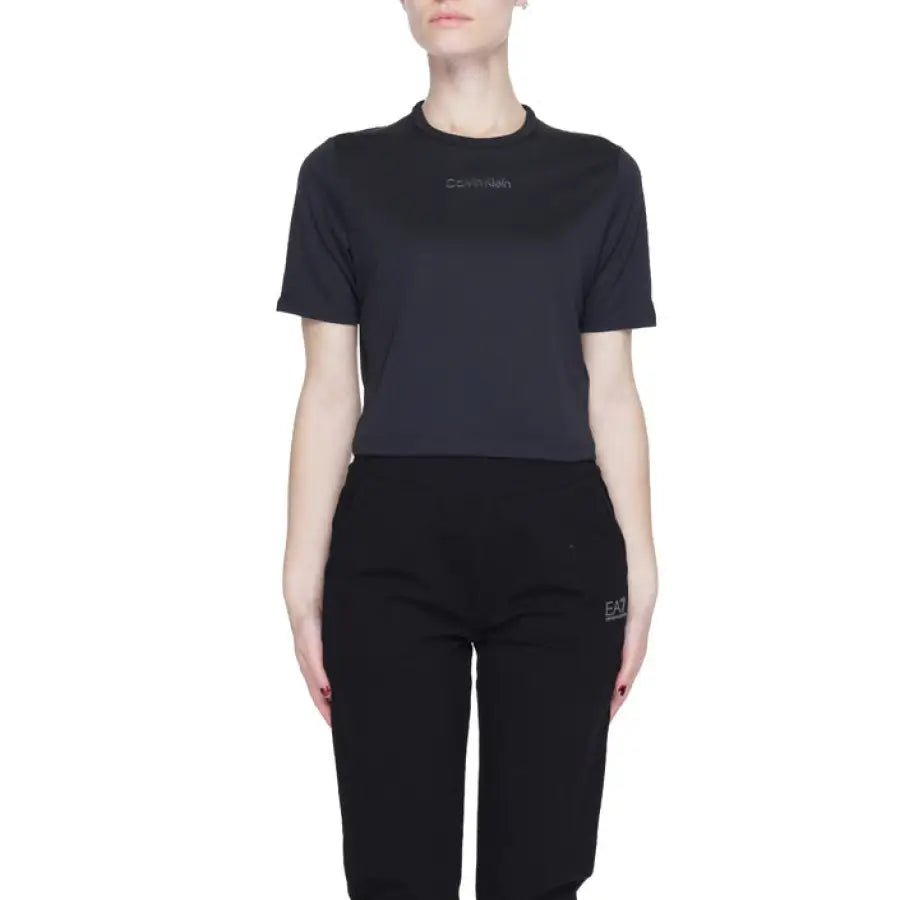 Woman in Calvin Klein Sport black t-shirt and pants