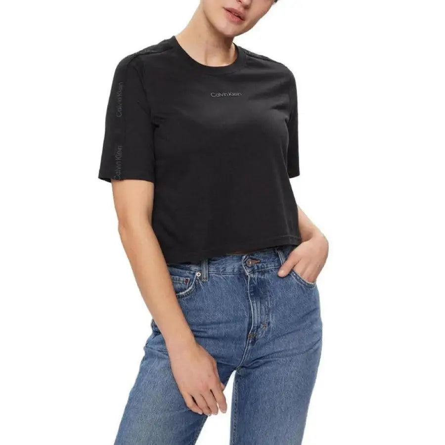 Woman in Calvin Klein Sport black t-shirt and jeans