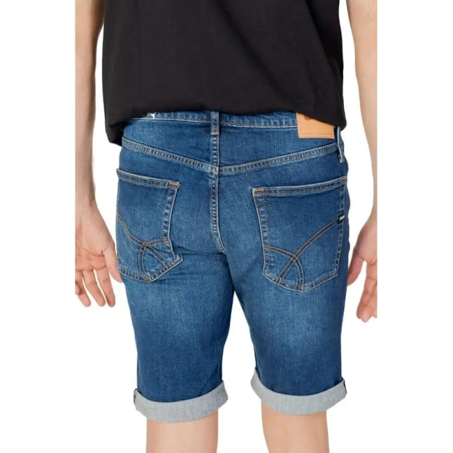 Woman in Gas Men Shorts, spring summer product with black t shirt.