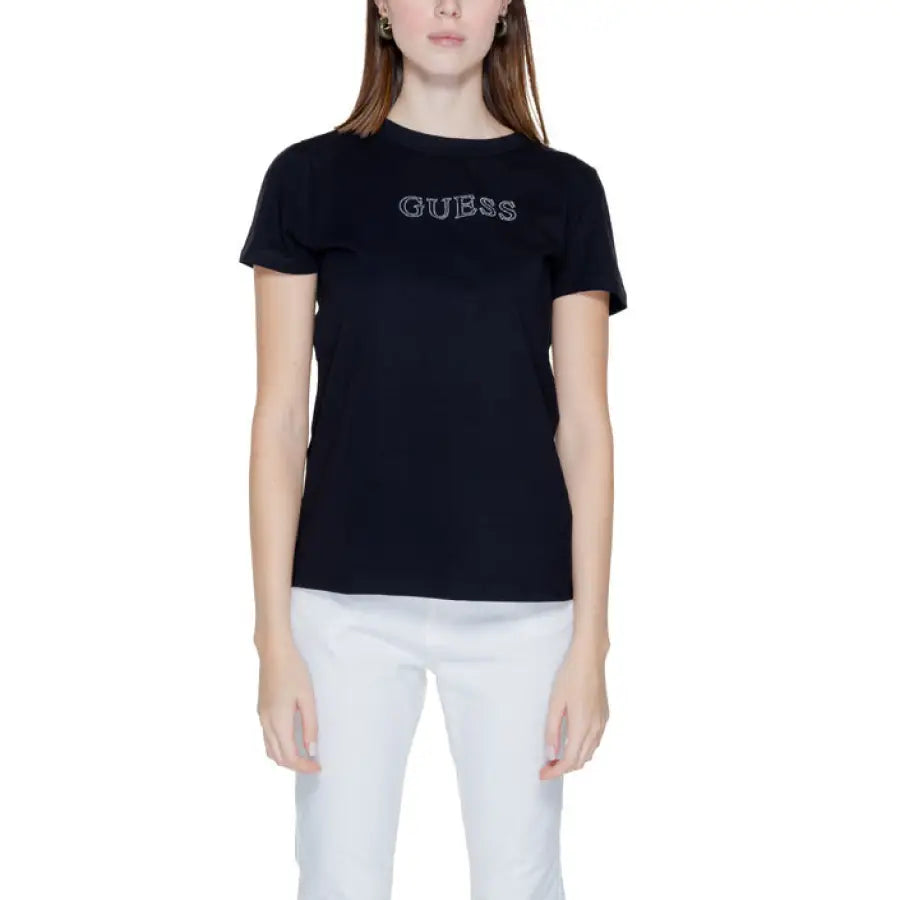 
                      
                        Woman in Guess Active black t-shirt with ’person’ print showcasing urban style clothing
                      
                    