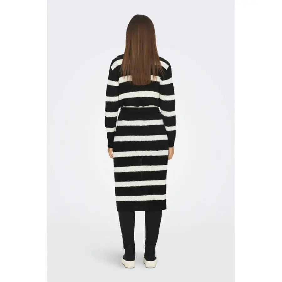
                      
                        Yong women cardigan featured in fall winter product, woman in striped sweater dress.
                      
                    