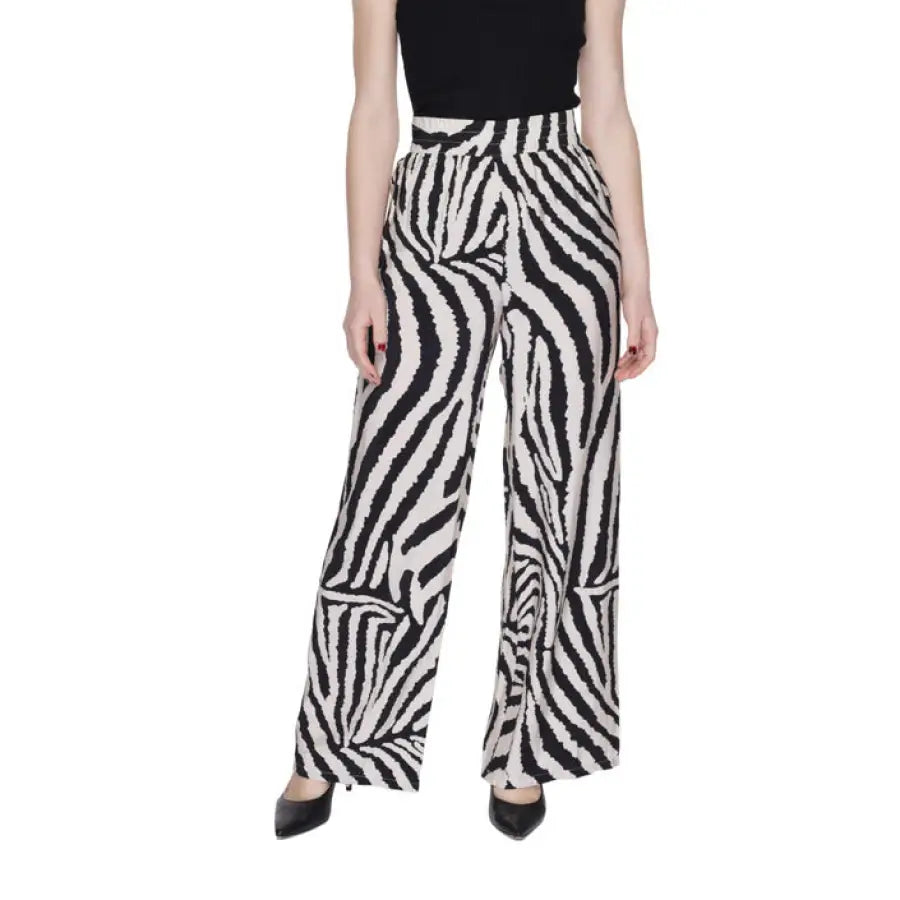 Woman in urban style clothing with zebra print pants by Jacqueline De Yong