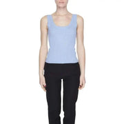 Woman in blue top, black pants showcasing Jacqueline De Yong urban style clothing