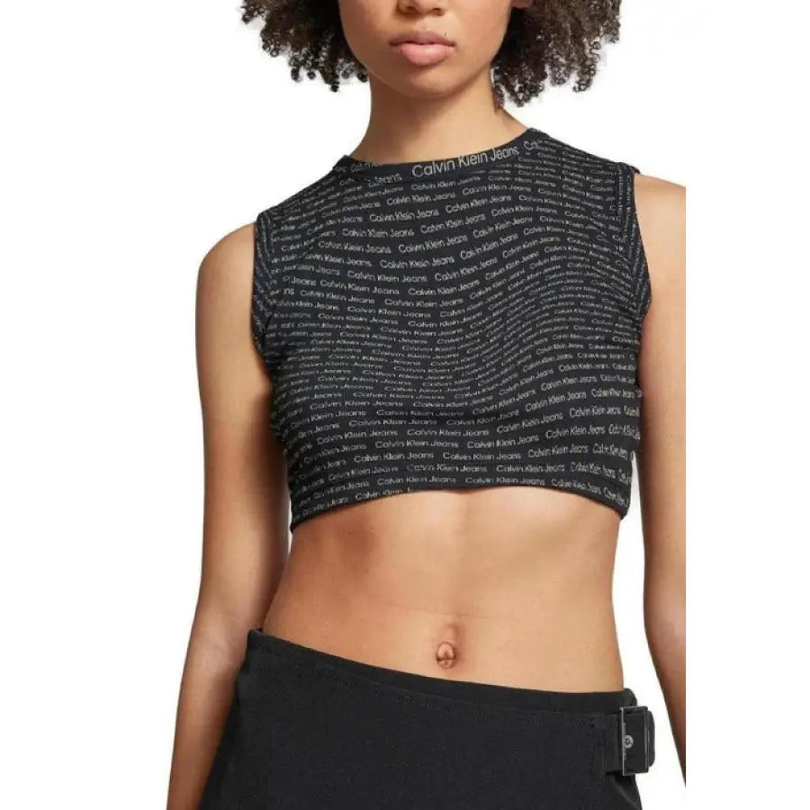 Woman in Calvin Klein Jeans crop top with black and white print