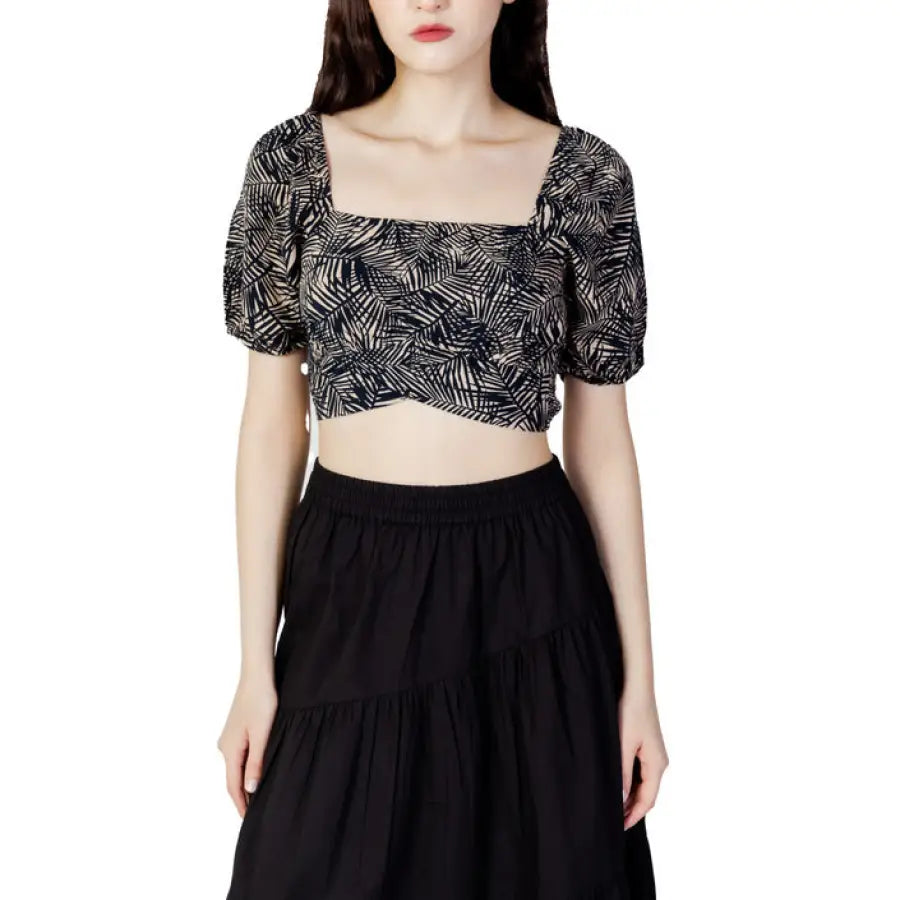 
                      
                        Woman in Only brand crop top and skirt embodying urban city style fashion
                      
                    