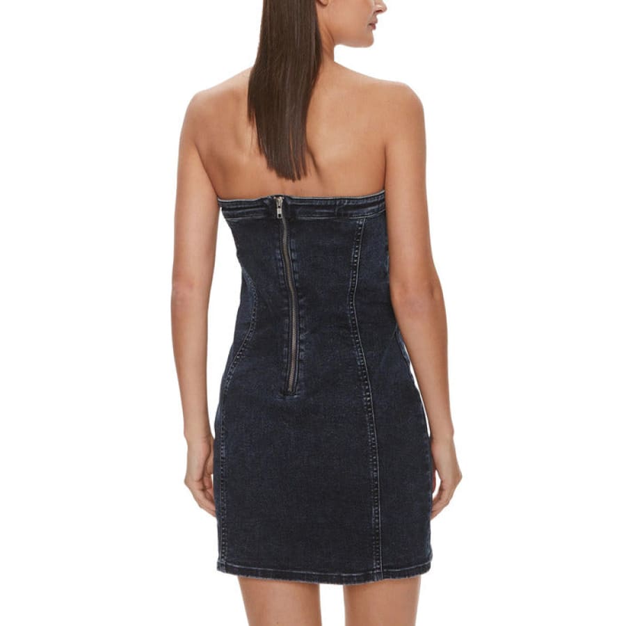 Woman in Calvin Klein Jeans denim dress with zipper feature