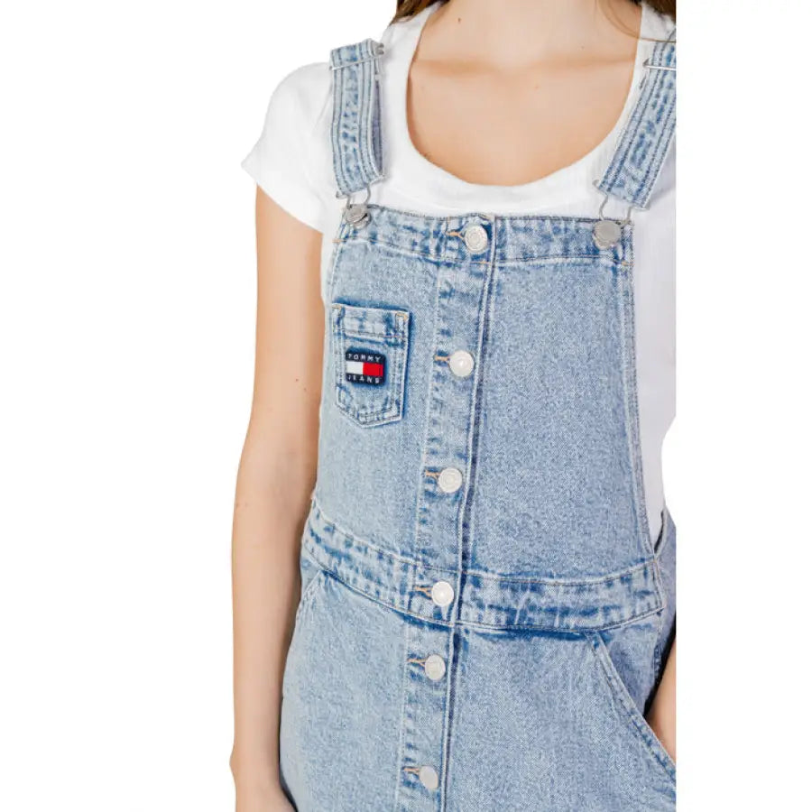 
                      
                        Tommy Hilfiger woman in a stylish denim overall dress by Hilfiger Jeans.
                      
                    