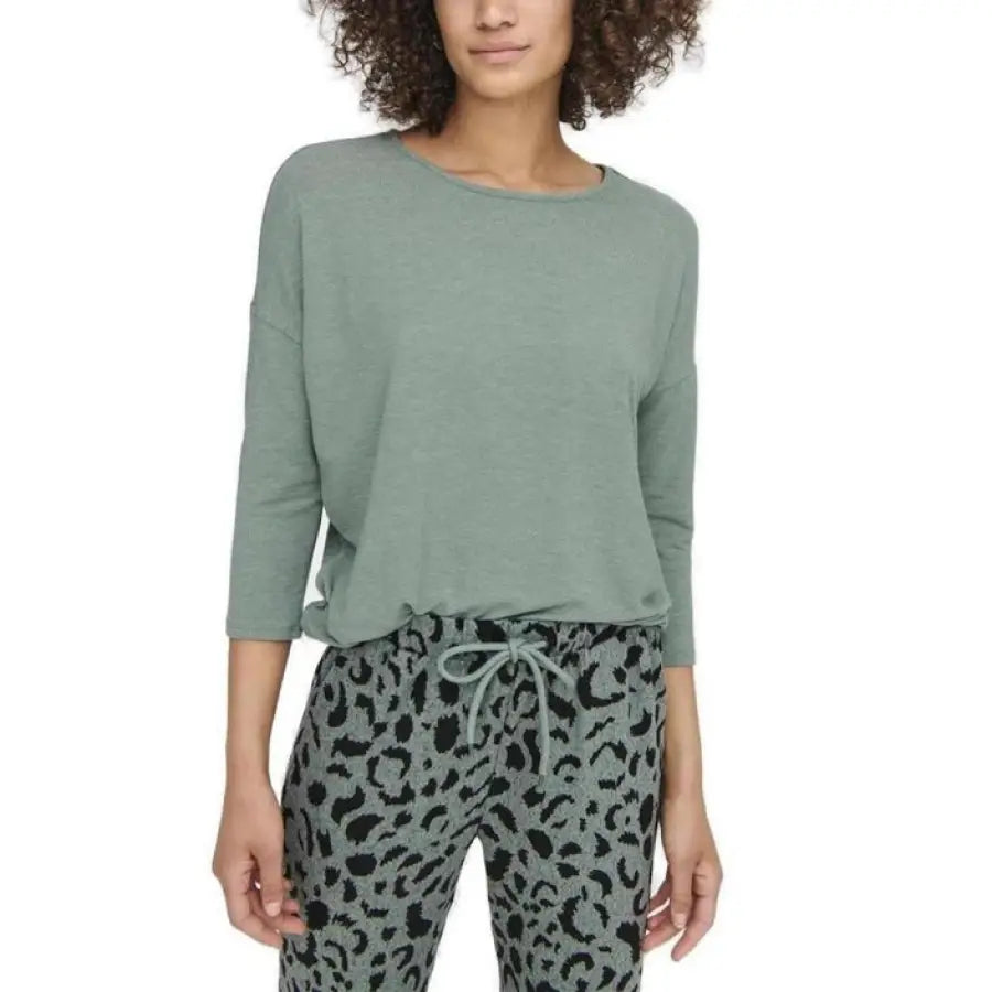 
                      
                        Woman in green top, leopard pants showcasing urban style clothing for Only brand
                      
                    