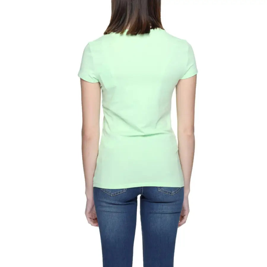 Woman wearing Armani Exchange green T-shirt, urban style clothing