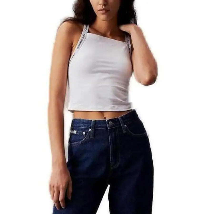 Woman modeling Calvin Klein Jeans and white undershirt for product feature