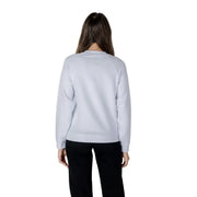 Woman wearing a light blue sweatshirt and black pants from Women’s Light Blue Sweatshirt and Black Pants collection