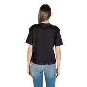 Woman from behind wearing a Calvin Klein Jeans black round neck short sleeve T shirt and blue jeans