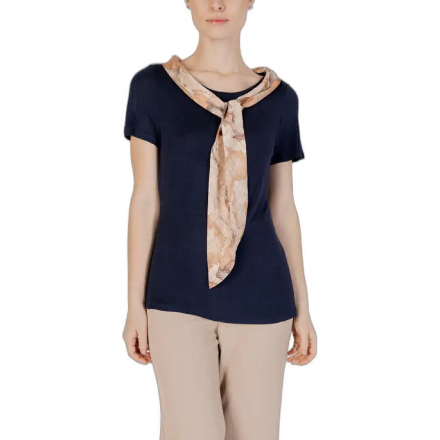 
                      
                        Alviero Martini Prima Classe woman in navy top with beige scarf
                      
                    