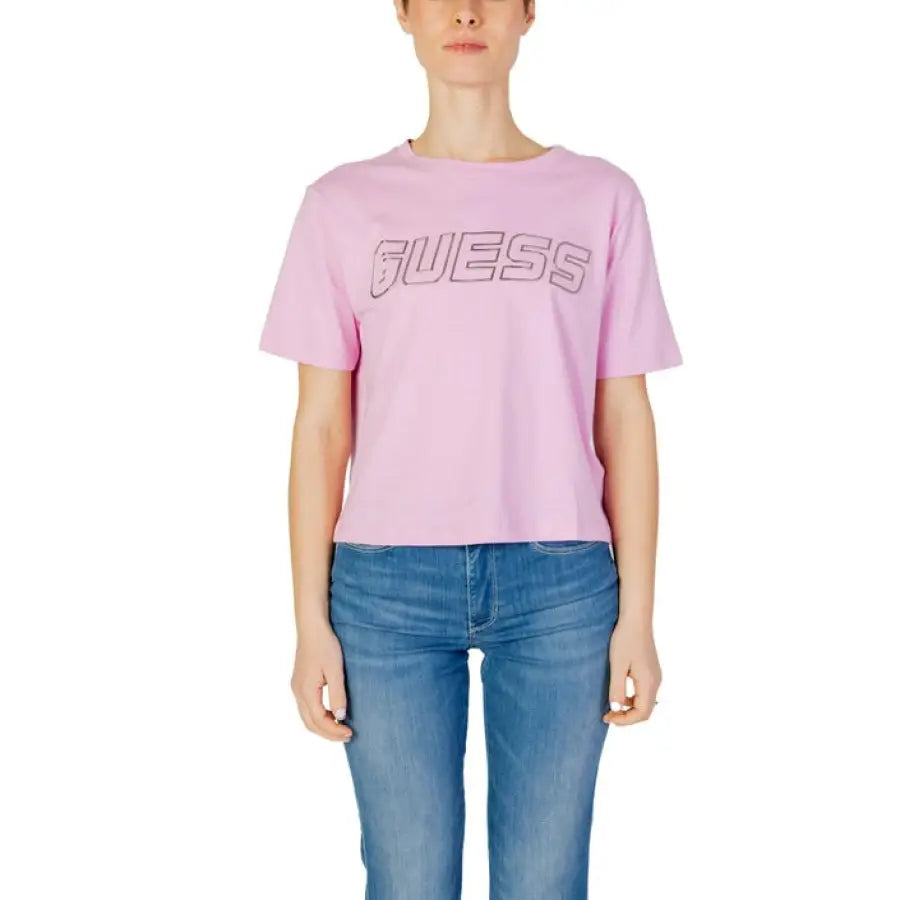 Woman in Guess Active pink t-shirt for urban city fashion