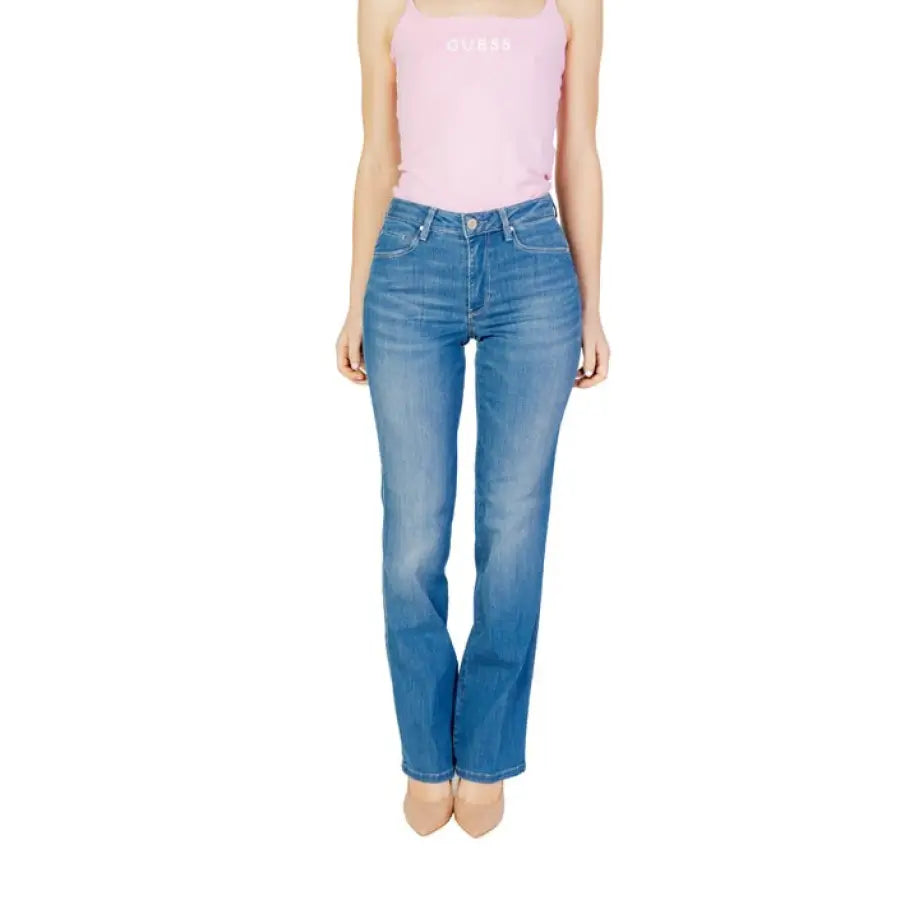 Woman in Guess women jeans and pink tank top showcasing Guess Guess style