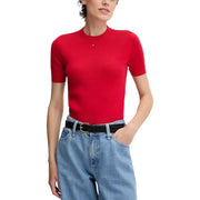 Woman wearing red mock neck top and light wash wide-leg jeans with black belt