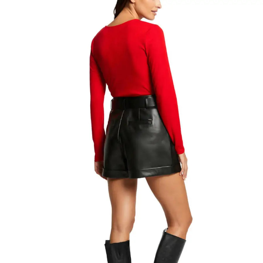 Woman in red sweater and leather skirt showcasing Morgan De Toi urban city fashion