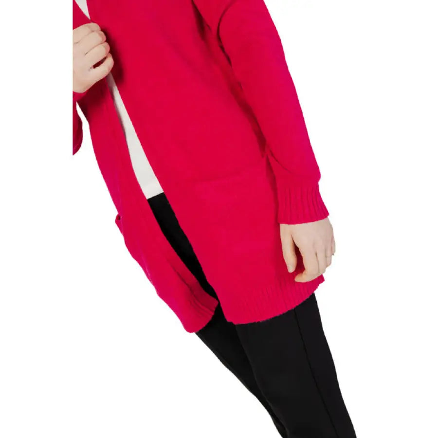 
                      
                        Woman in Vila Clothes cardigan, red sweater, and black pants
                      
                    