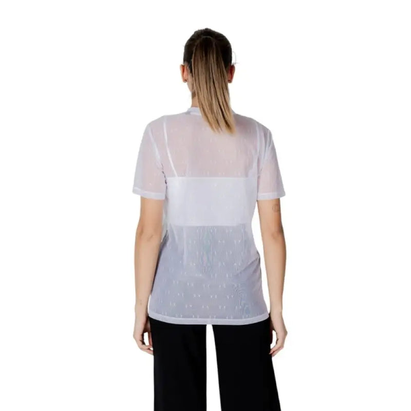 Woman wearing a sheer white top with a white tank beneath, featured in Women’s Sheer Top with White Tank product image