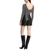 Woman wearing Morgan De Toi Black Striped Long Sleeve Sweater with leather shorts and boots