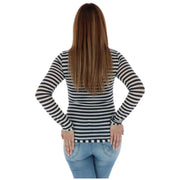 Woman in striped long sleeve shirt with anchor embellishment and jeans posing outdoors