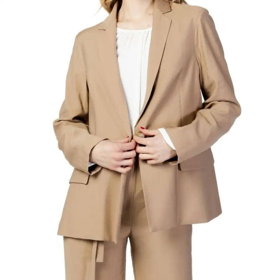 Sandro Ferrone woman in tan suit blazer