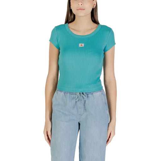 Woman wearing Calvin Klein Jeans light blue short sleeve round neck T shirt and drawstring pants