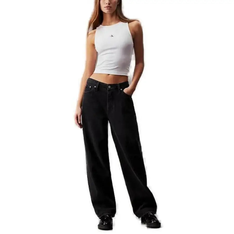
                      
                        Woman modeling Calvin Klein top and black jeans for Calvin Klein Jeans product
                      
                    