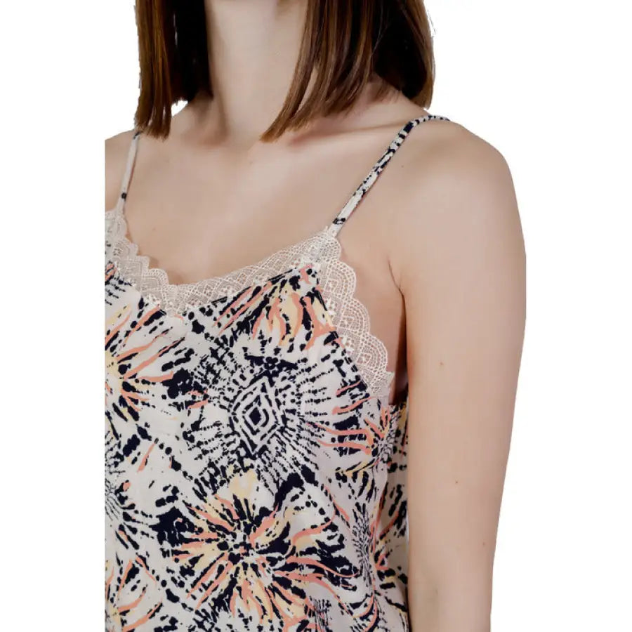 
                      
                        Woman in Jacqueline De Yong top with floral print, showcasing urban style clothing
                      
                    