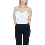 Woman in white top and black pants for Only Women Undershirt, urban city style clothing