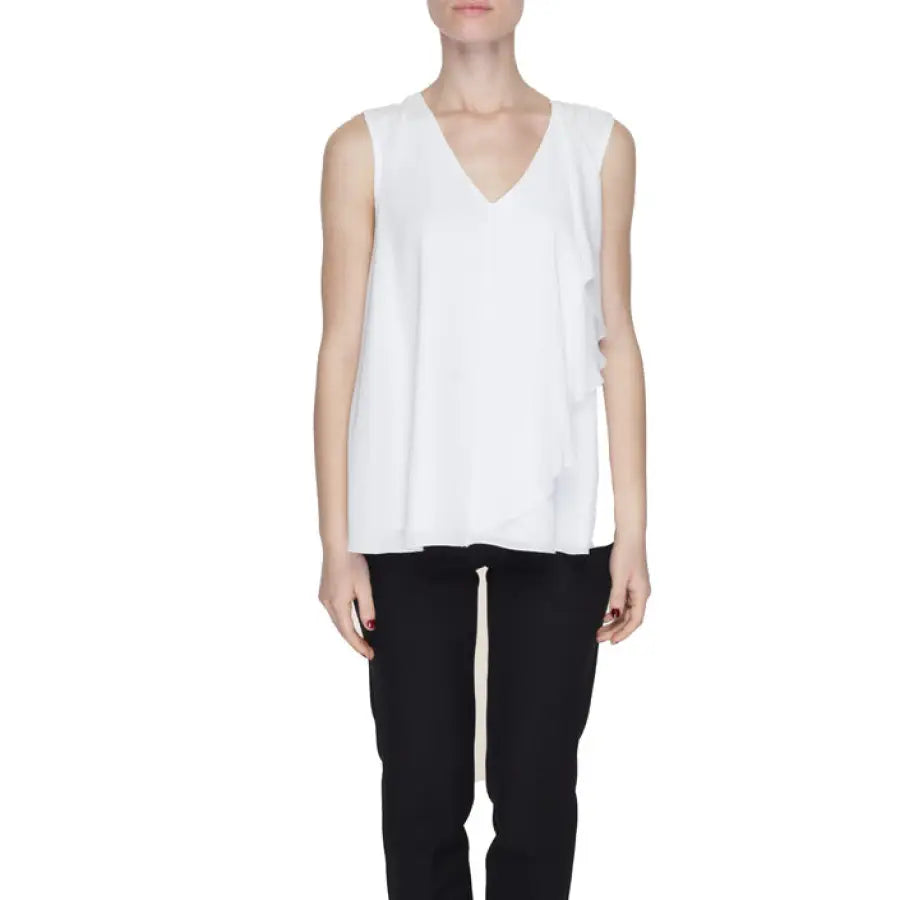Urban fashion: Sandro Ferrone woman in white blouse and black pants