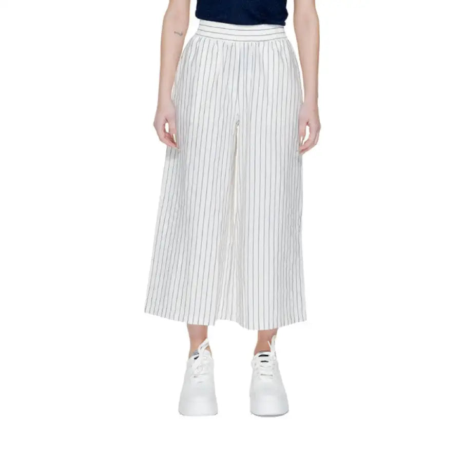 Vero Moda woman in urban style clothing with black and white striped trousers