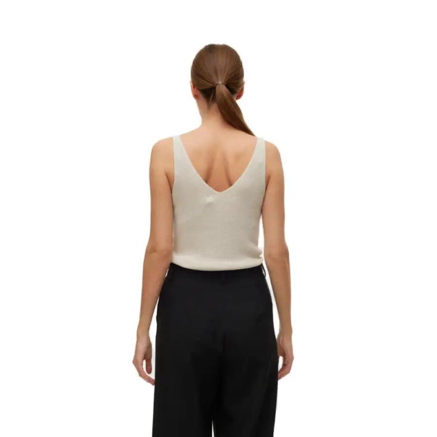 Vero Moda urban style clothing, woman in white top and black pants, urban city fashion