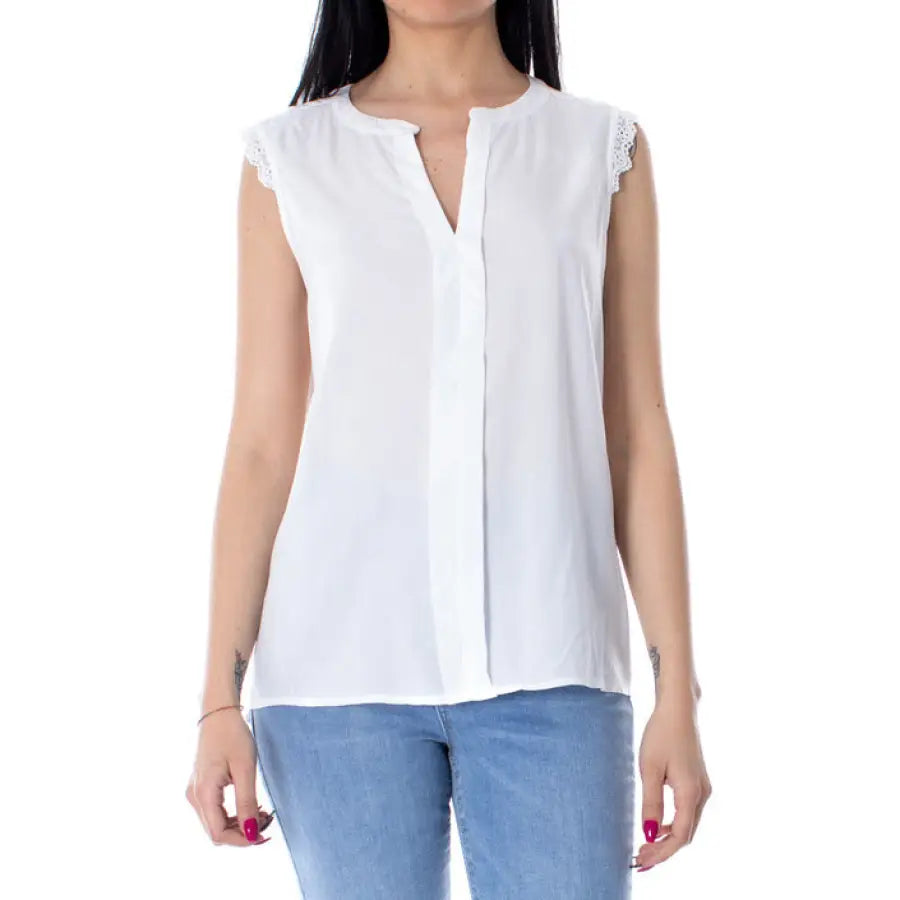
                      
                        Woman in white blouse and jeans showcasing urban city style clothing
                      
                    