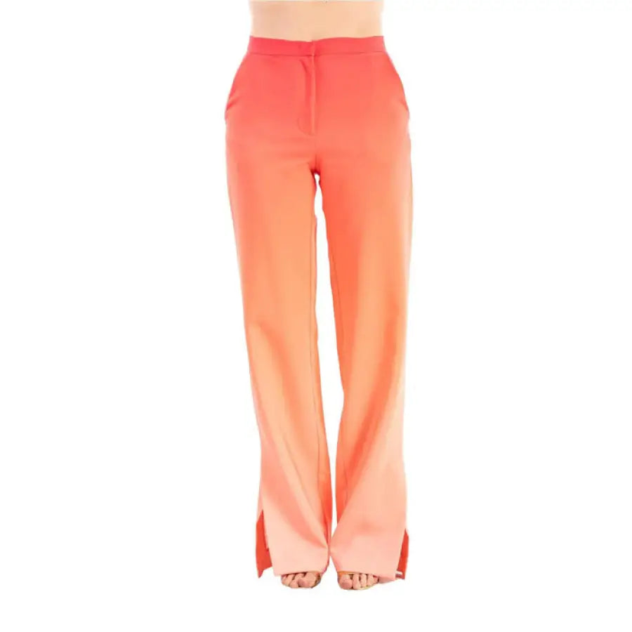 
                      
                        Woman in white top and orange Silence trousers showcasing urban city style fashion
                      
                    